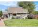 Charming single Gathering home showcasing a well-manicured lawn, mature trees and colorful flowers at 2595 S Irving St, Denver, CO 80219