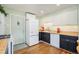 Open kitchen has butcher block countertops, white cabinets, and classic refrigerator at 2595 S Irving St, Denver, CO 80219