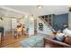 Cozy living space flows into kitchen and dining area with hardwood flooring at 2595 S Irving St, Denver, CO 80219