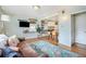 Open living room with wood floors, connected to the dining area and kitchen at 2595 S Irving St, Denver, CO 80219