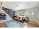 Bright living room features stylish decor, hardwood floors, and an open staircase at 2595 S Irving St, Denver, CO 80219