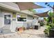 Charming patio area with flagstone pavers, outdoor seating, and a sunshade sail at 2595 S Irving St, Denver, CO 80219