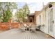 The back deck area offers an enjoyable outdoor space with elegant seating and a lovely brick perimeter at 2909 Glenarm Pl, Denver, CO 80205