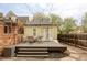 Cozy backyard features a wooden deck with outdoor seating and charming string lights above at 2909 Glenarm Pl, Denver, CO 80205
