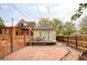 Spacious backyard with brick patio and wooden deck, perfect for outdoor entertaining and relaxation at 2909 Glenarm Pl, Denver, CO 80205