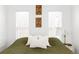 Bright bedroom features a bed with olive green quilt, white walls, and modern decor at 2909 Glenarm Pl, Denver, CO 80205