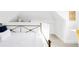 Bright bedroom features white walls, bed with white bedding, and modern gold accents at 2909 Glenarm Pl, Denver, CO 80205
