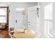 Bright dining area with wood table, white chairs, and stylish light fixture at 2909 Glenarm Pl, Denver, CO 80205