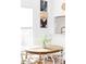 Close-up of a dining table set with flowers, surrounded by white chairs and natural lighting at 2909 Glenarm Pl, Denver, CO 80205