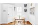 Bright dining area with a wooden table, white chairs, pendant lighting, and neutral decor at 2909 Glenarm Pl, Denver, CO 80205