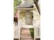 Inviting front porch featuring decorative white railings and a walkway through the lawn at 2909 Glenarm Pl, Denver, CO 80205