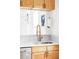 Bright kitchen features modern gold faucet, white countertops, and natural wood cabinets at 2909 Glenarm Pl, Denver, CO 80205