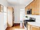 Well-lit kitchen with wooden cabinets, white countertops, and stainless steel appliances at 2909 Glenarm Pl, Denver, CO 80205