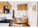 Updated kitchen featuring wood cabinets, stainless steel appliances, and hardwood floors at 2909 Glenarm Pl, Denver, CO 80205