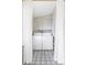 Updated laundry room with shelving, new washer and dryer, and trendy tiled floors at 2909 Glenarm Pl, Denver, CO 80205