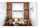 Stylish living room showcasing an exposed brick wall, a comfortable sofa, and ample natural light at 2909 Glenarm Pl, Denver, CO 80205