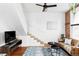 Modern living room featuring hardwood floors, a brick wall, and stairs to the second floor at 2909 Glenarm Pl, Denver, CO 80205