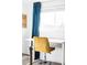 Bright office with yellow chair, modern desk, and natural light at 2909 Glenarm Pl, Denver, CO 80205