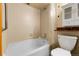 Neutral bathroom featuring a tiled shower-tub combination, and a white toilet and vanity at 8225 Fairmount Dr # 102, Denver, CO 80247