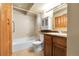 Neutral bathroom with white fixtures and wood vanity at 8225 Fairmount Dr # 102, Denver, CO 80247