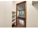 Walk-in closet with installed shelving; door is visible leading to bedroom with window at 8225 Fairmount Dr # 102, Denver, CO 80247