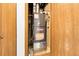 Goodman furnace housed in a closet with wood doors at 8225 Fairmount Dr # 102, Denver, CO 80247