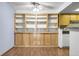 Open living space featuring wood floors and built in shelves at 8225 Fairmount Dr # 102, Denver, CO 80247