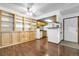 Open living space with wood floors, built in shelves and access to kitchen at 8225 Fairmount Dr # 102, Denver, CO 80247