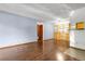 Spacious living area featuring hardwood floors, built-in shelving, and natural light at 8225 Fairmount Dr # 102, Denver, CO 80247
