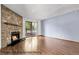 Bright and spacious living room featuring a stone fireplace and access to a private balcony at 8225 Fairmount Dr # 102, Denver, CO 80247