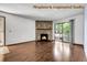 Bright living room featuring a stone fireplace and sliding glass doors to the balcony at 8225 Fairmount Dr # 102, Denver, CO 80247