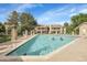 Community pool surrounded by landscaped grounds; multiple residents enjoying the water at 8225 Fairmount Dr # 102, Denver, CO 80247