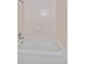 Clean white bathroom with a tile surround and shower head at 8438 Everett Way # B, Arvada, CO 80005