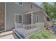Close up view of a charming home featuring a inviting porch with white picket fence at 8438 Everett Way # B, Arvada, CO 80005