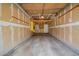 Spacious garage with exposed framing, unfinished walls, and overhead storage, offering a blank canvas at 8438 Everett Way # B, Arvada, CO 80005