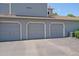 Exterior shot of a well-maintained garage unit featuring 3 parking spots, set against a neat gray exterior at 8438 Everett Way # B, Arvada, CO 80005