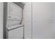 Efficient laundry room features a stacked washer and dryer unit maximizing space, with utility closet at 8438 Everett Way # B, Arvada, CO 80005