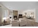 Spacious living room with a stone fireplace, plush seating, and an adjacent dining area at 8438 Everett Way # B, Arvada, CO 80005