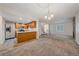 Open-concept living area adjacent to the kitchen with stone fireplace at 8438 Everett Way # B, Arvada, CO 80005