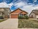 Inviting single-Gathering home featuring a well-kept lawn and concrete driveway leading to an attached garage at 4118 Desert Ridge Cir, Castle Rock, CO 80108