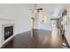 Open living room with hardwood floors, fireplace, and seamless flow into the kitchen area at 4118 Desert Ridge Cir, Castle Rock, CO 80108