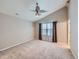 Large main bedroom showcasing high ceilings, a ceiling fan, and a window with curtains at 4118 Desert Ridge Cir, Castle Rock, CO 80108