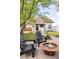 Backyard with a fire pit, manicured lawn, and a charming home exterior with black trim and a cozy setting at 1484 Cherry St, Denver, CO 80220