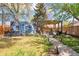 Backyard oasis with artistic mural, hot tub, pergola, and outdoor seating area at 1484 Cherry St, Denver, CO 80220