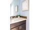 Bathroom featuring a granite countertop, stylish backsplash, and soft blue walls at 1484 Cherry St, Denver, CO 80220