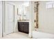 Well-lit bathroom with modern fixtures, bathtub and shower, and a sleek dark vanity at 1484 Cherry St, Denver, CO 80220