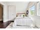 Comfortable bedroom showcasing natural light, hardwood floors, and a neutral color palette at 1484 Cherry St, Denver, CO 80220