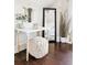 Stylish bedroom space with a contemporary desk, decorative mirror, and cozy pouf at 1484 Cherry St, Denver, CO 80220