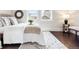 Bright bedroom featuring a decorative rug, hardwood floors, and sunny windows at 1484 Cherry St, Denver, CO 80220