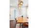 Bright dining room with unique lighting fixture, wooden table, and access to other rooms at 1484 Cherry St, Denver, CO 80220
